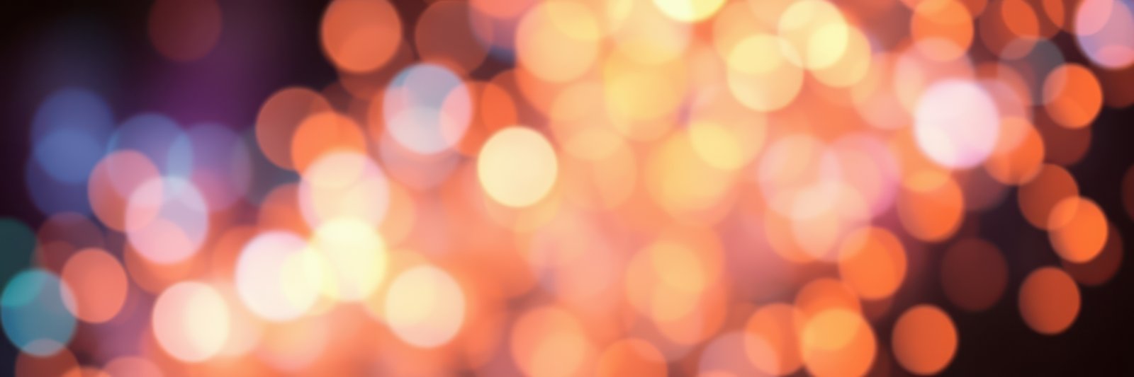 Vibrant bokeh lights create a warm atmosphere at a nighttime celebration in a festive setting